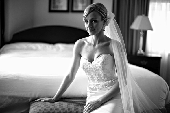 Bride Sitting in Front of Bed